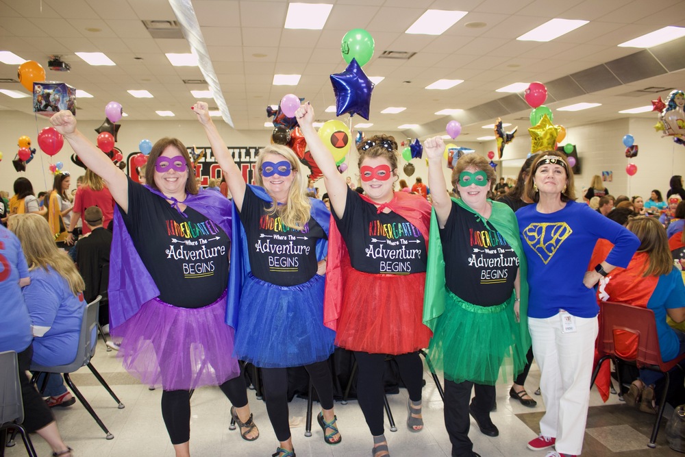 Teachers dressed up as super heros at the Back to School Breakfast