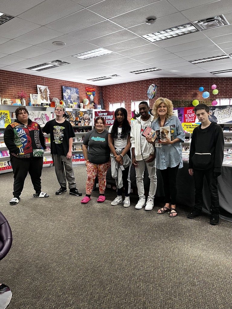 teachers and students holding books