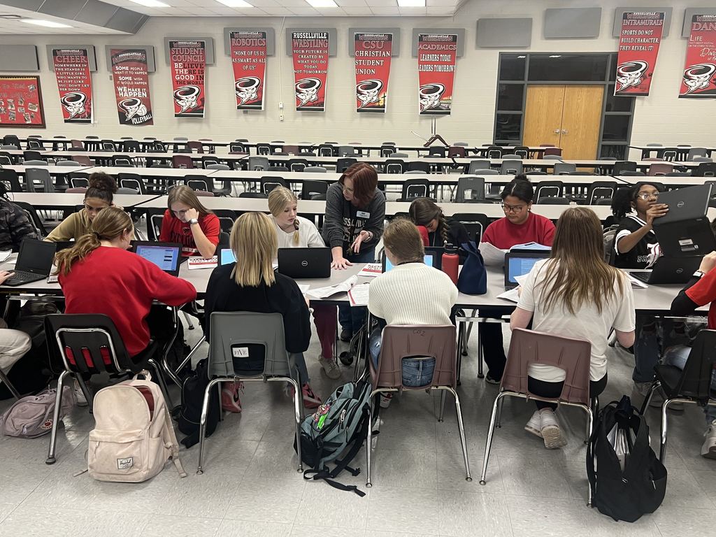 students sitting and working with the career coach