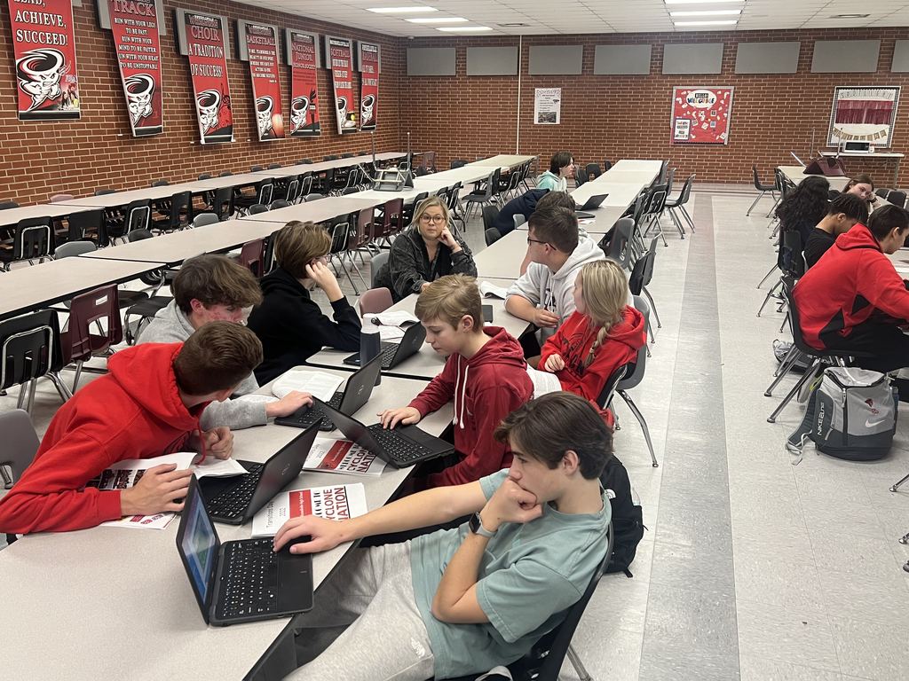 students working on computers in the cafeteria