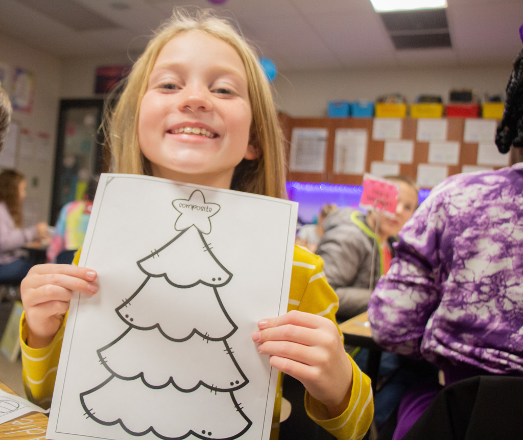 Students decorating Christmas trees with math