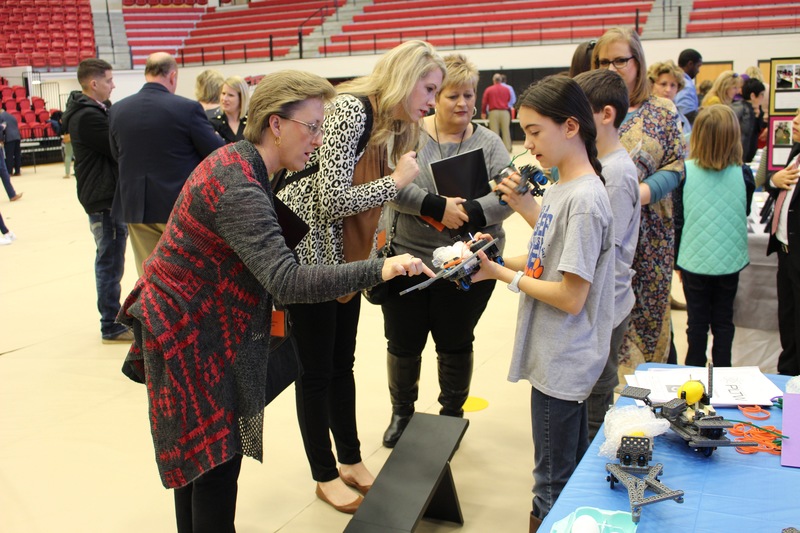 Students demonstrate their project at the PLTW Showcase in Cyclone Arena