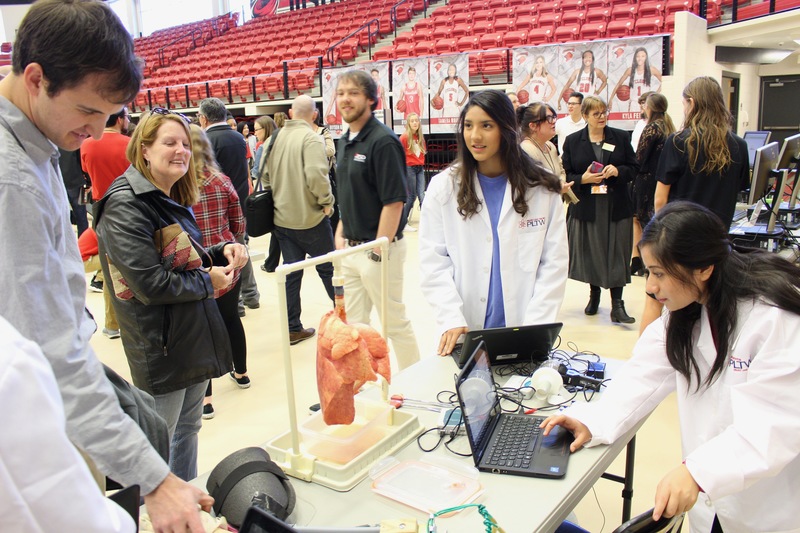 Biomedical students demonstrate their project at the PLTW Showcase in Cyclone Arena